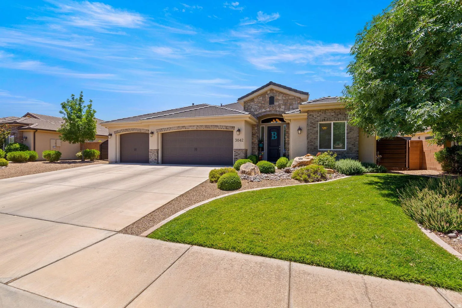 Stone and stucco exterior with an arched entryway