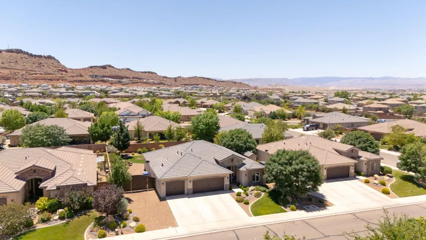 Expansive residential neighborhood featuring single-story homes with tile roofs, mature landscaping, and multi-car garages