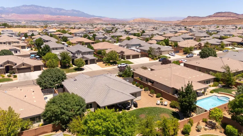 Aerial perspective showcasing a residential development with distant mountainous terrain