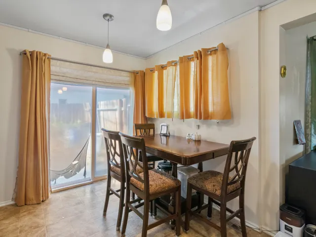 Dining area featuring tile flooring and pendant lighting