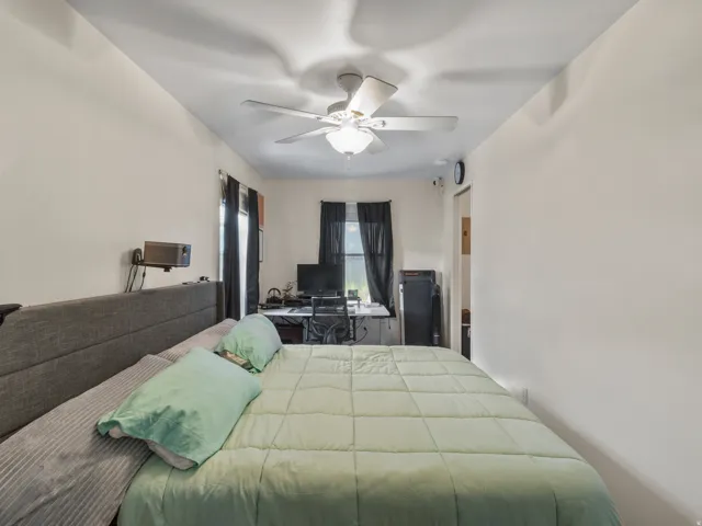 White walls with a ceiling fan and recessed lighting