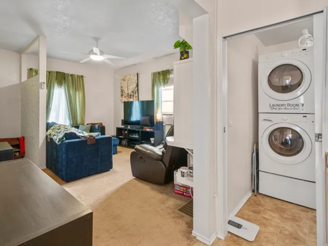Dedicated laundry closet featuring a stacked washer and dryer unit