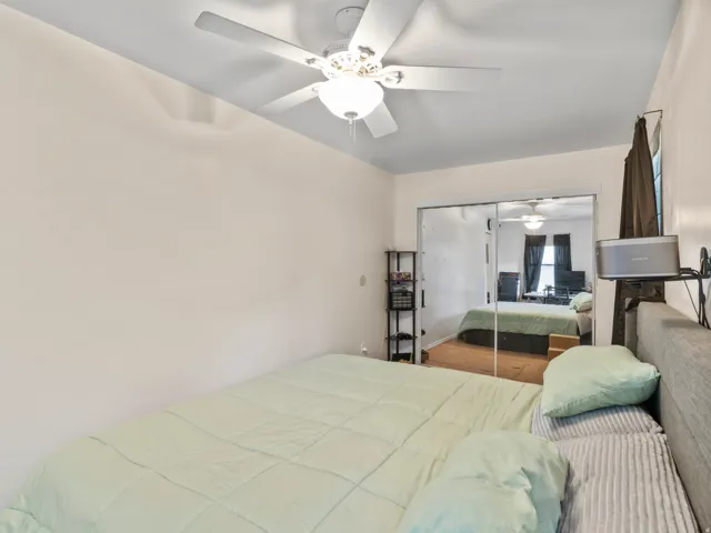 Room featuring a ceiling fan with integrated lighting, mirrored sliding closet doors, and light-toned wall paint