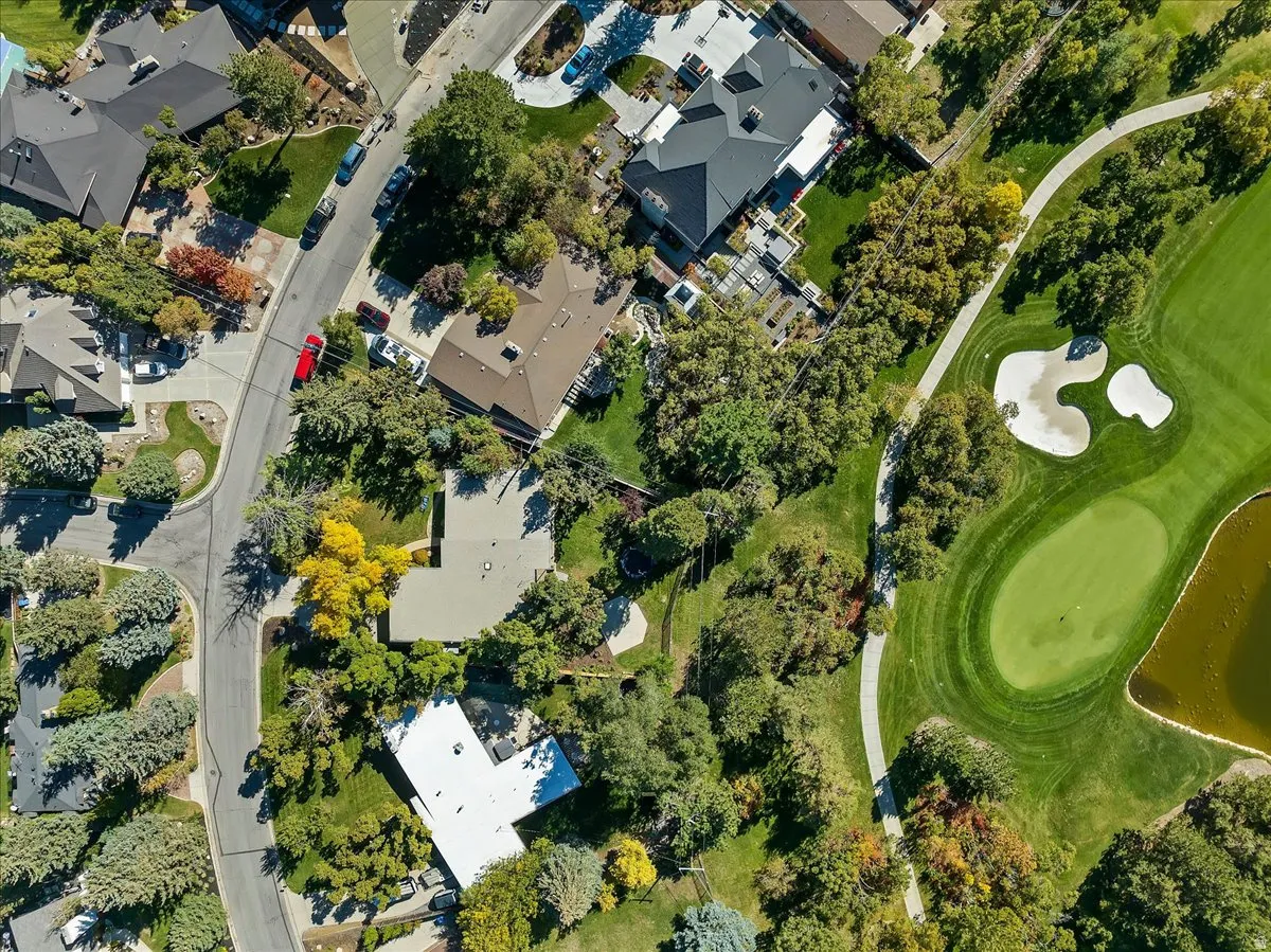 Aerial view showcasing a residential area bordered by a golf course