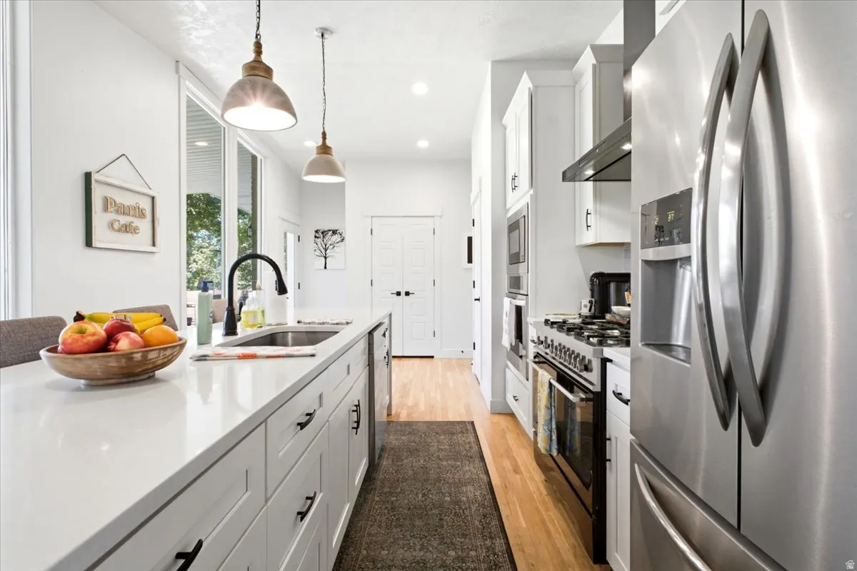 Modern kitchen featuring white cabinetry and light-toned countertops