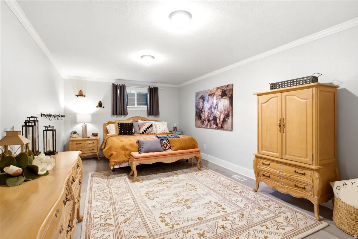 Spacious room featuring light gray walls, white trim, recessed lighting, and wood-finish flooring