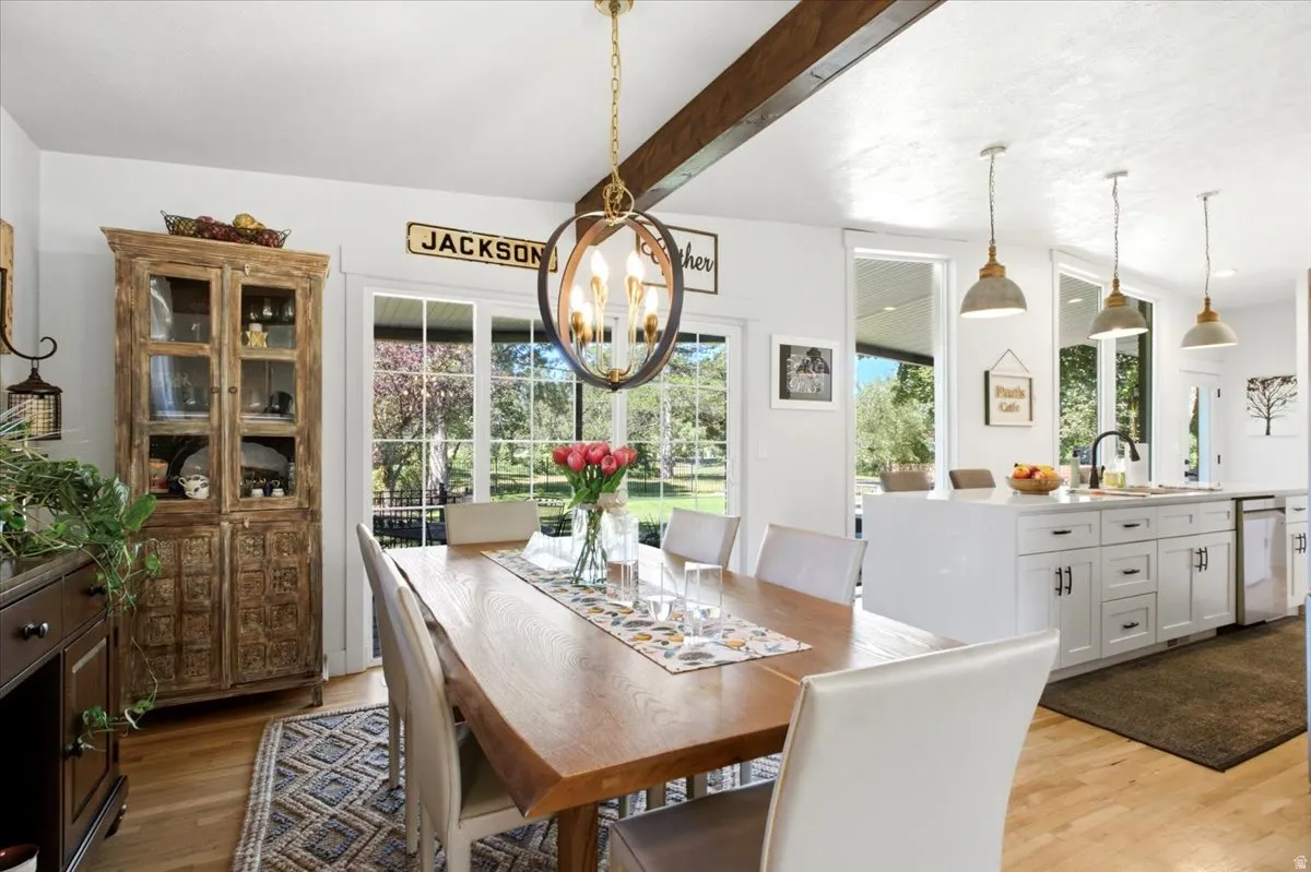 Open-concept dining area featuring a wood-finish dining table and hardwood flooring