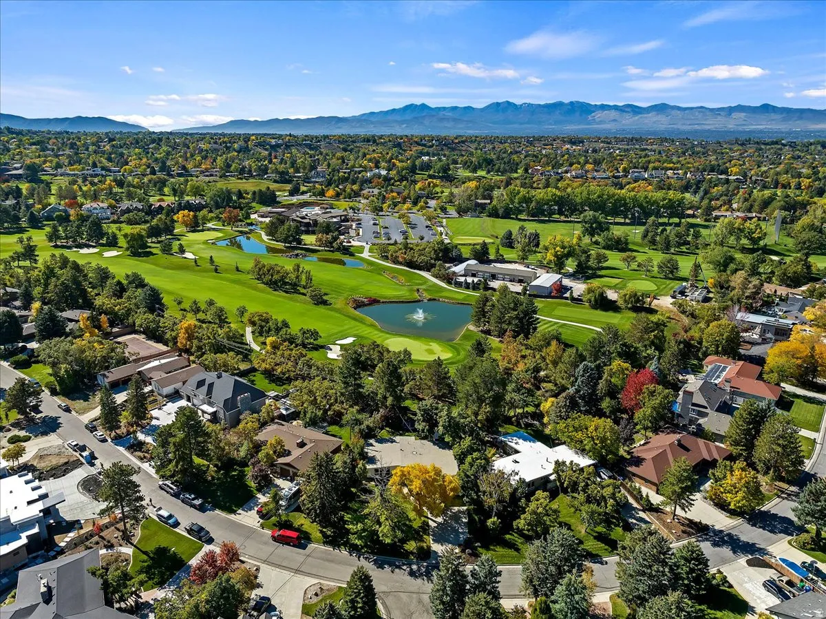 Expansive golf course landscape with multiple greens and water features