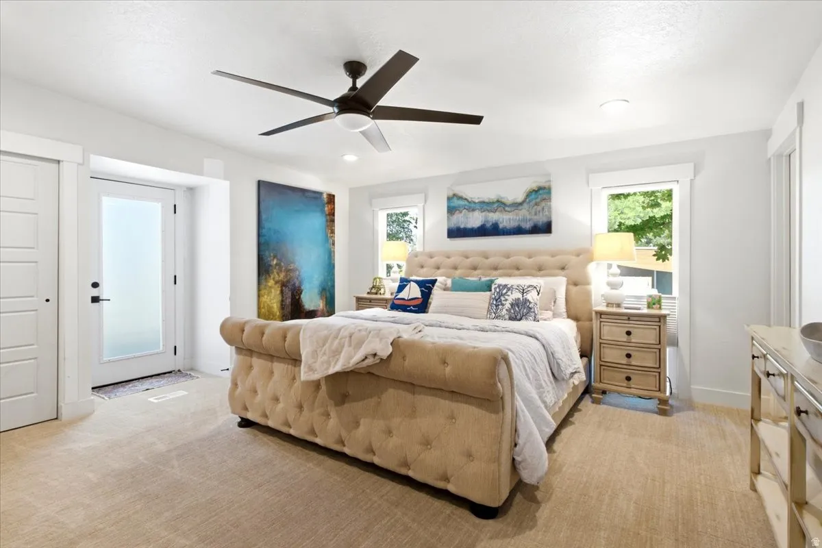 Spacious room featuring neutral carpeting, a contemporary ceiling fan, recessed lighting, white trim, and a frosted glass panel door
