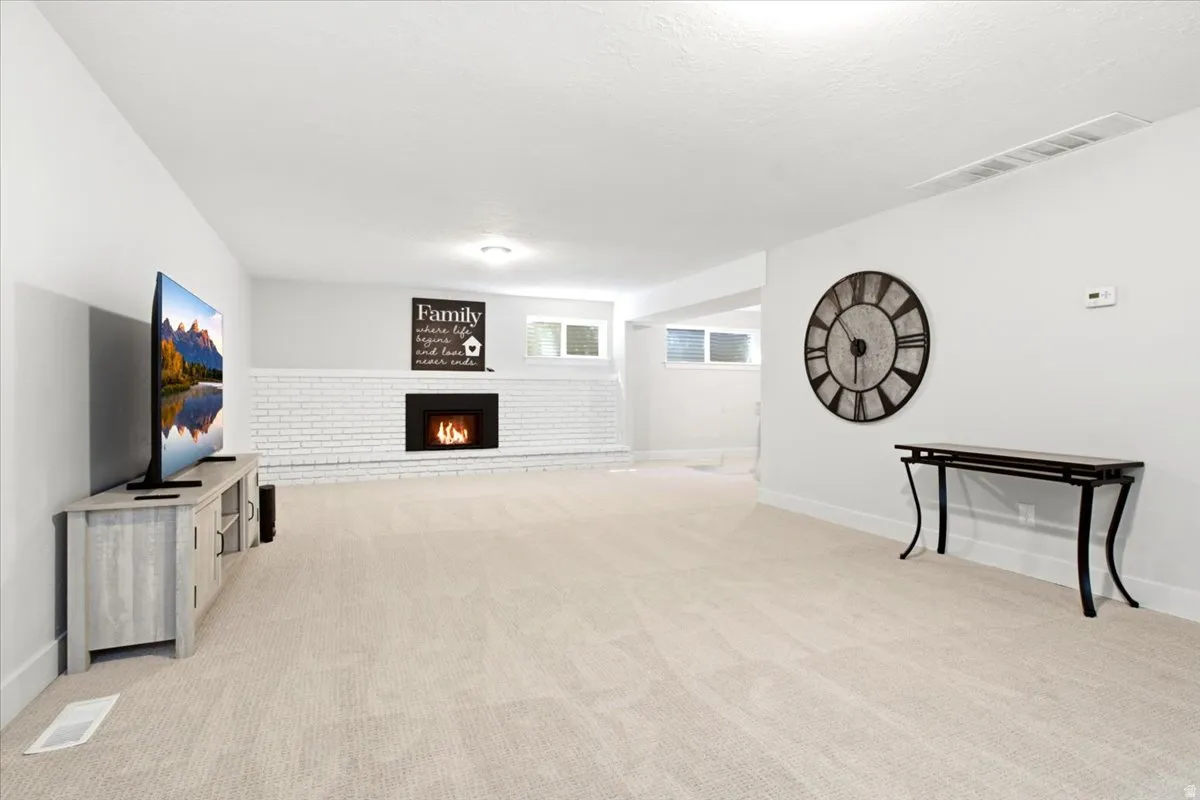 Spacious room featuring light-toned carpeting and white walls