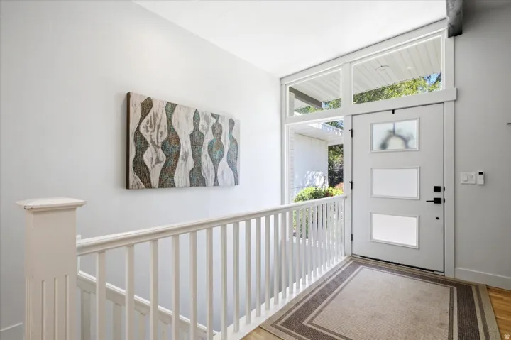 Contemporary entry door featuring three frosted glass panels and transom windows