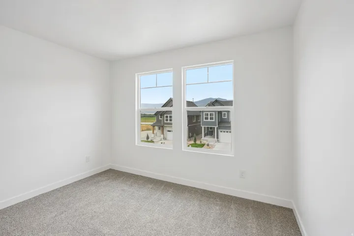 Neutral color palette, dual windows, gray carpet, white walls, white trim