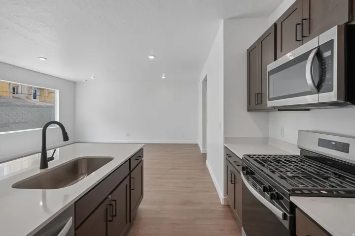Kitchen island with an undermount sink and matte black gooseneck faucet