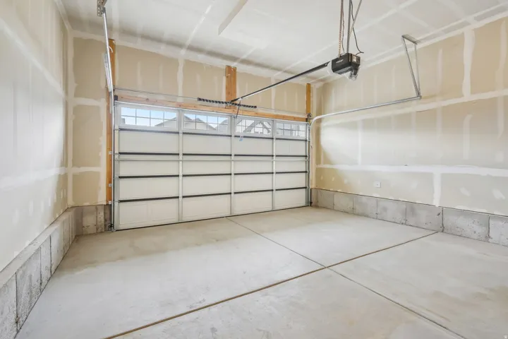 Concrete flooring, overhead garage door with windows, automatic garage door opener, unfinished walls