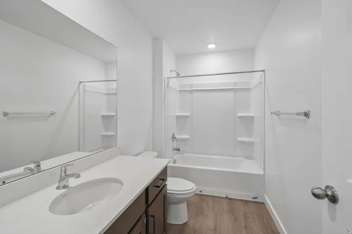 Contemporary bathroom with a single vanity, integrated sink, and white countertop