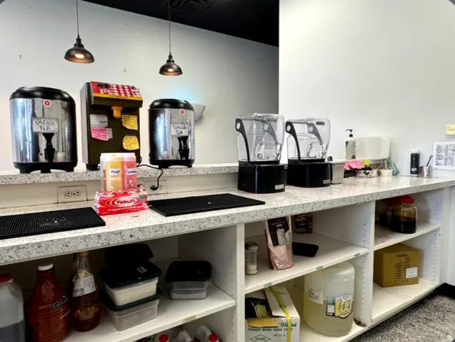 Countertop workspace with integrated shelving, featuring a speckled light-toned surface
