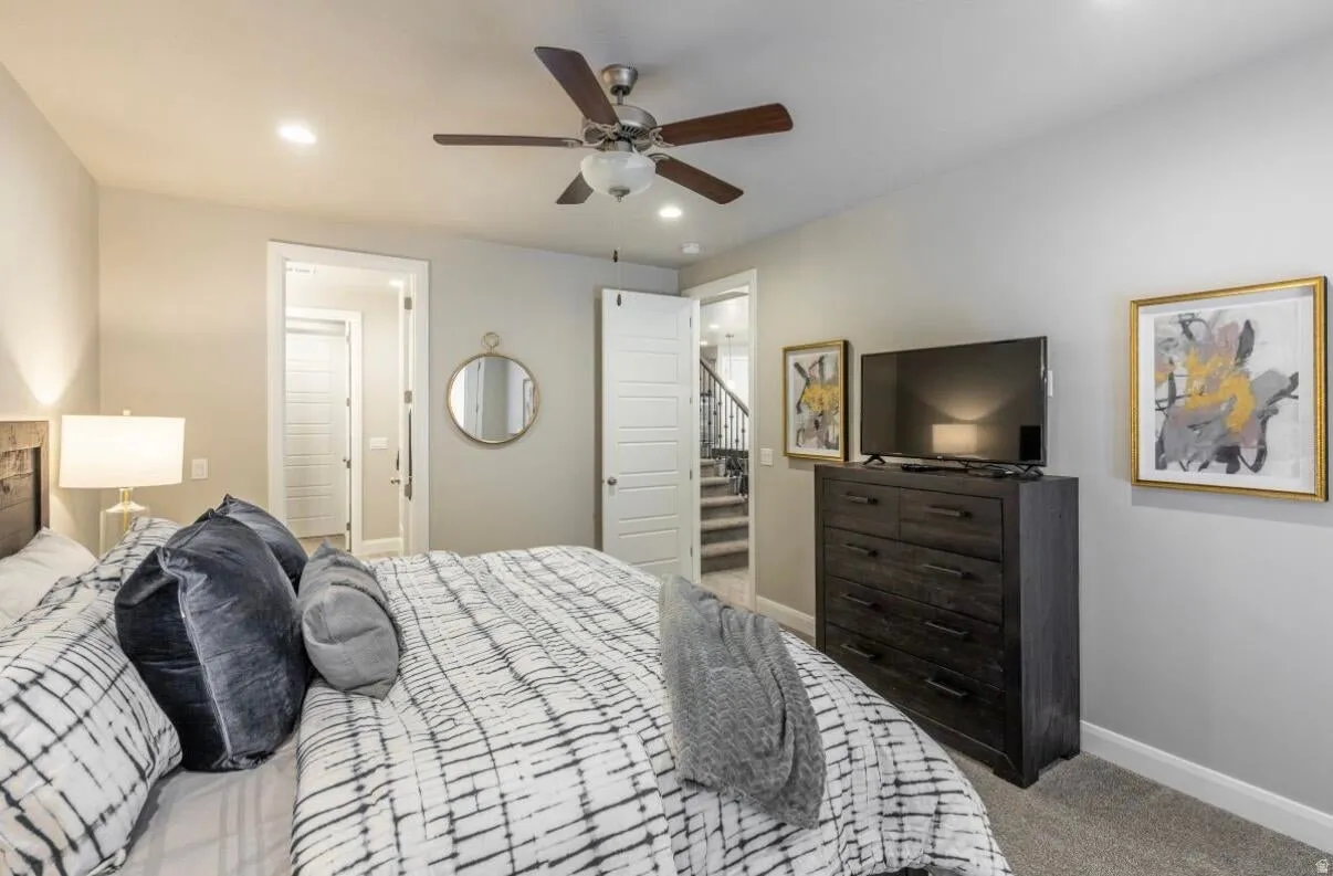 Bedroom featuring light gray walls, recessed lighting, and a ceiling fan