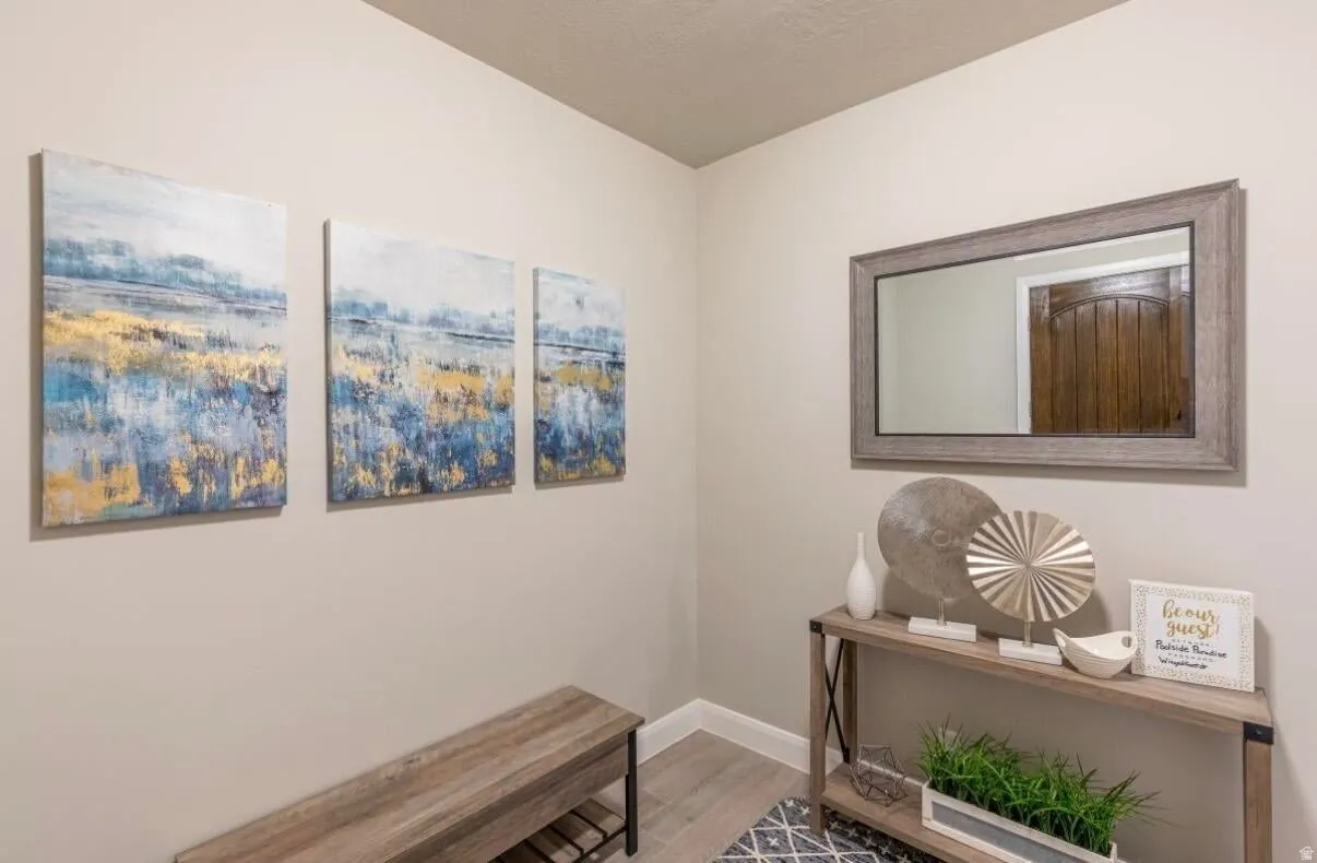 Light-toned walls complement wood-finish flooring in this entry area