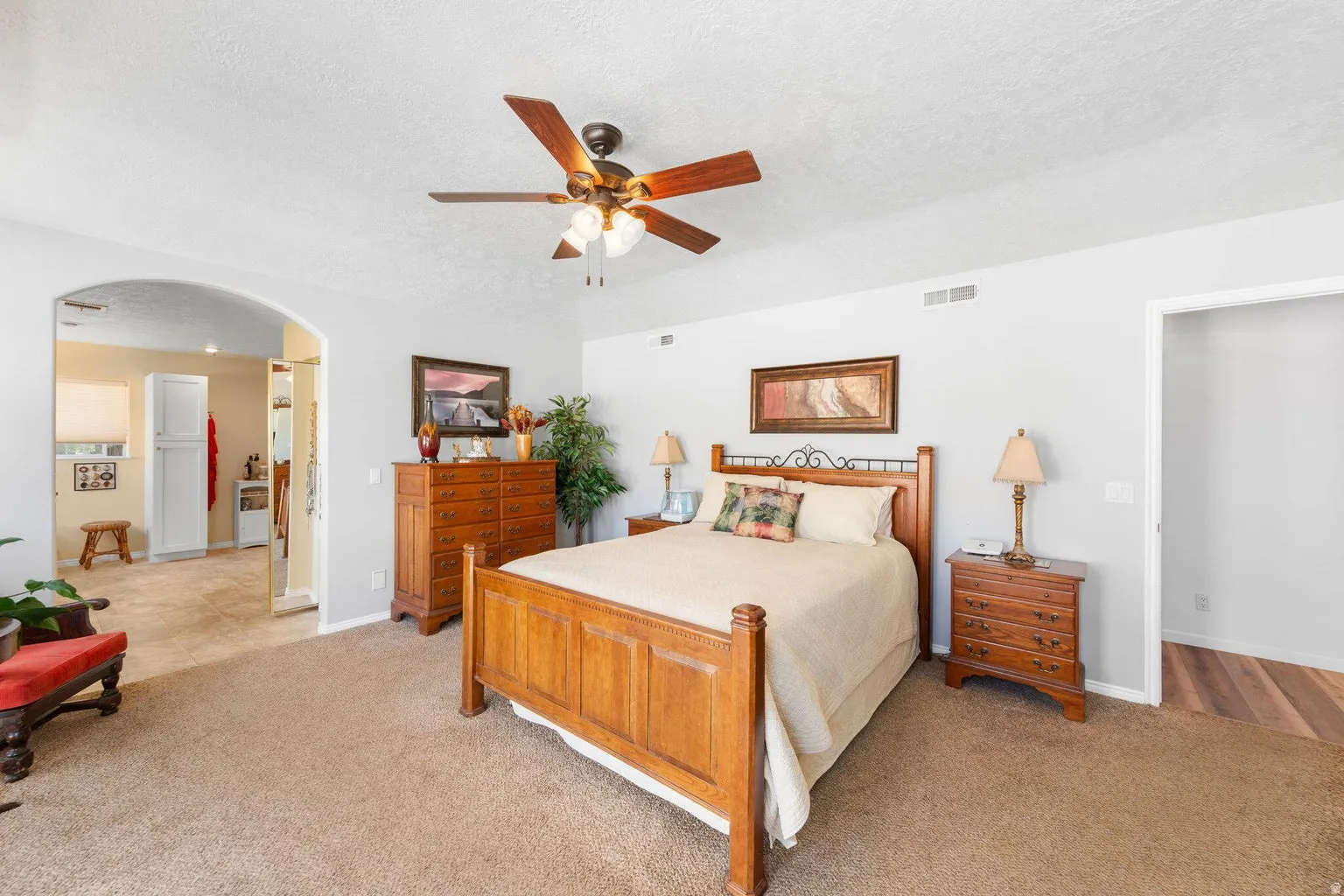 Spacious interior featuring neutral wall tones and a ceiling fan with integrated lighting