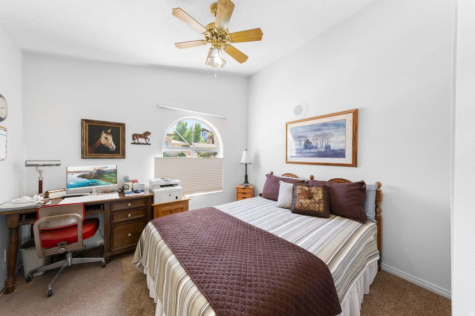 Light-filled room featuring a semicircular window, recessed ceiling fan, textured carpeting, and a built-in ceiling speaker