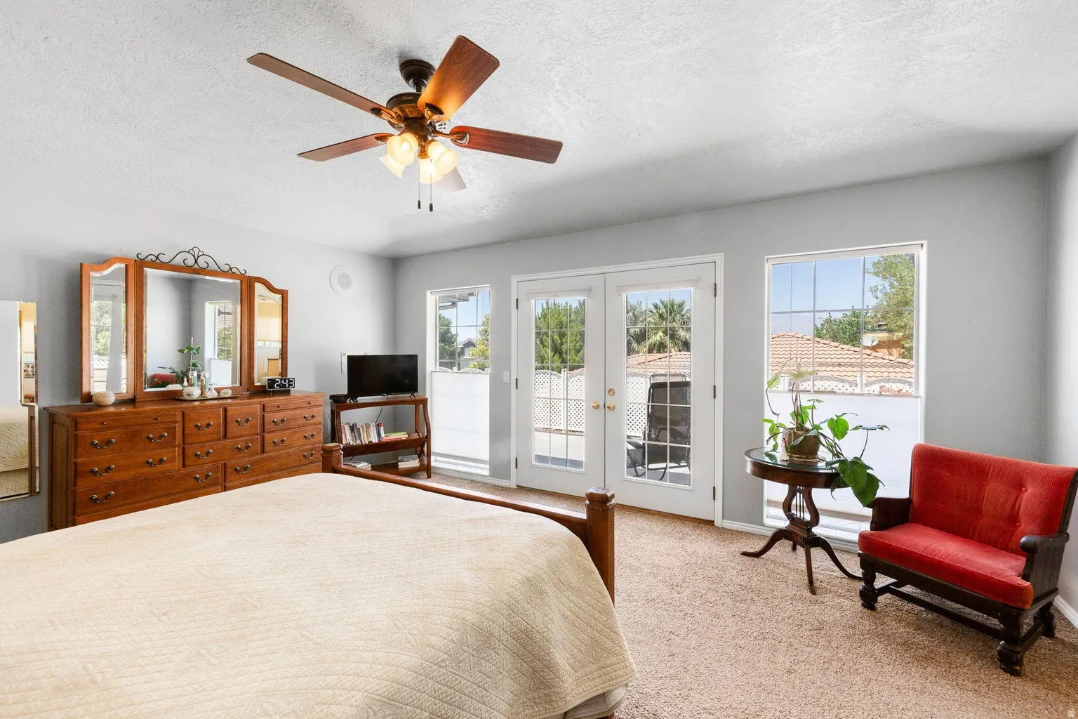 Room featuring French doors and an adjacent window with exterior views