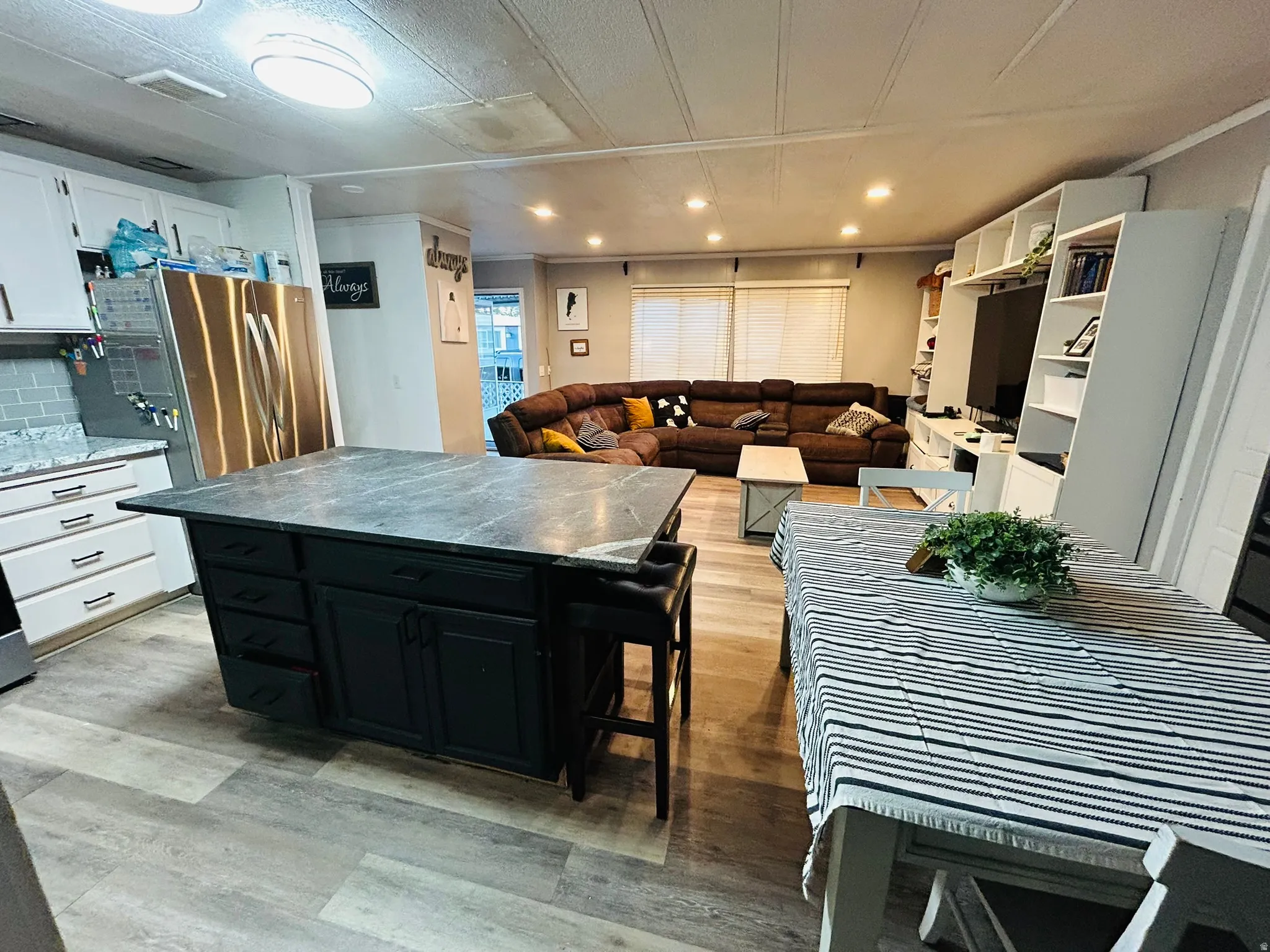 Spacious open-concept living area featuring wood-finish flooring