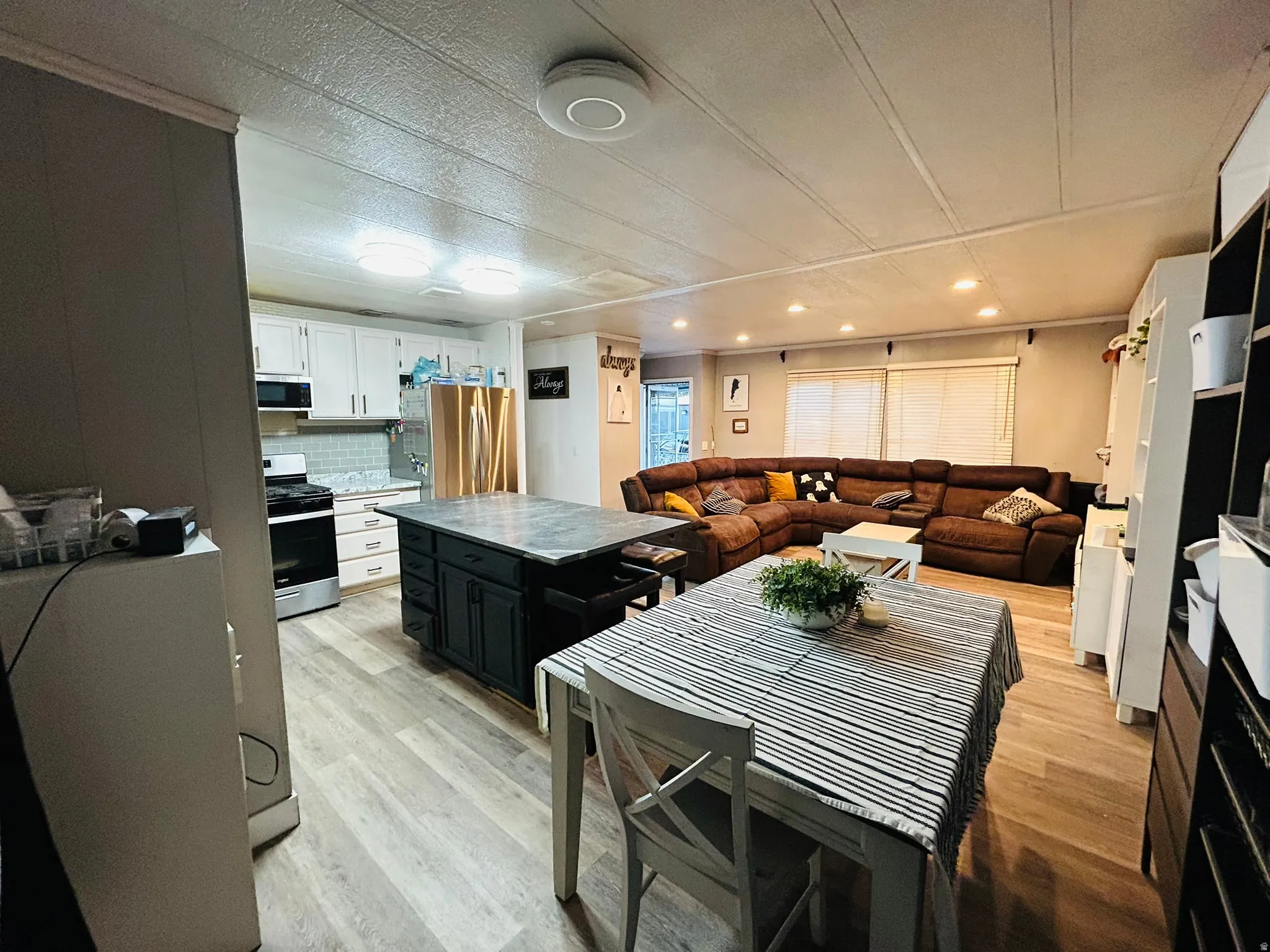 Open-concept living space featuring wood-finish flooring throughout