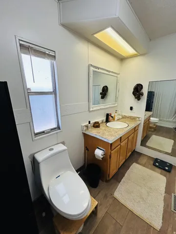 Bathroom vanity featuring a light-colored countertop and wood-finish cabinetry