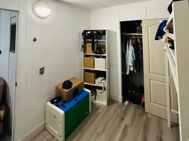 Room featuring wood-finish flooring and a textured ceiling