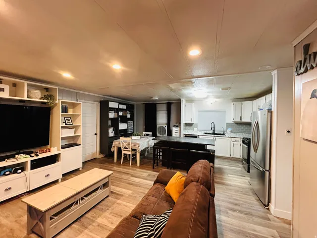 Open-concept living area with wood-finish flooring
