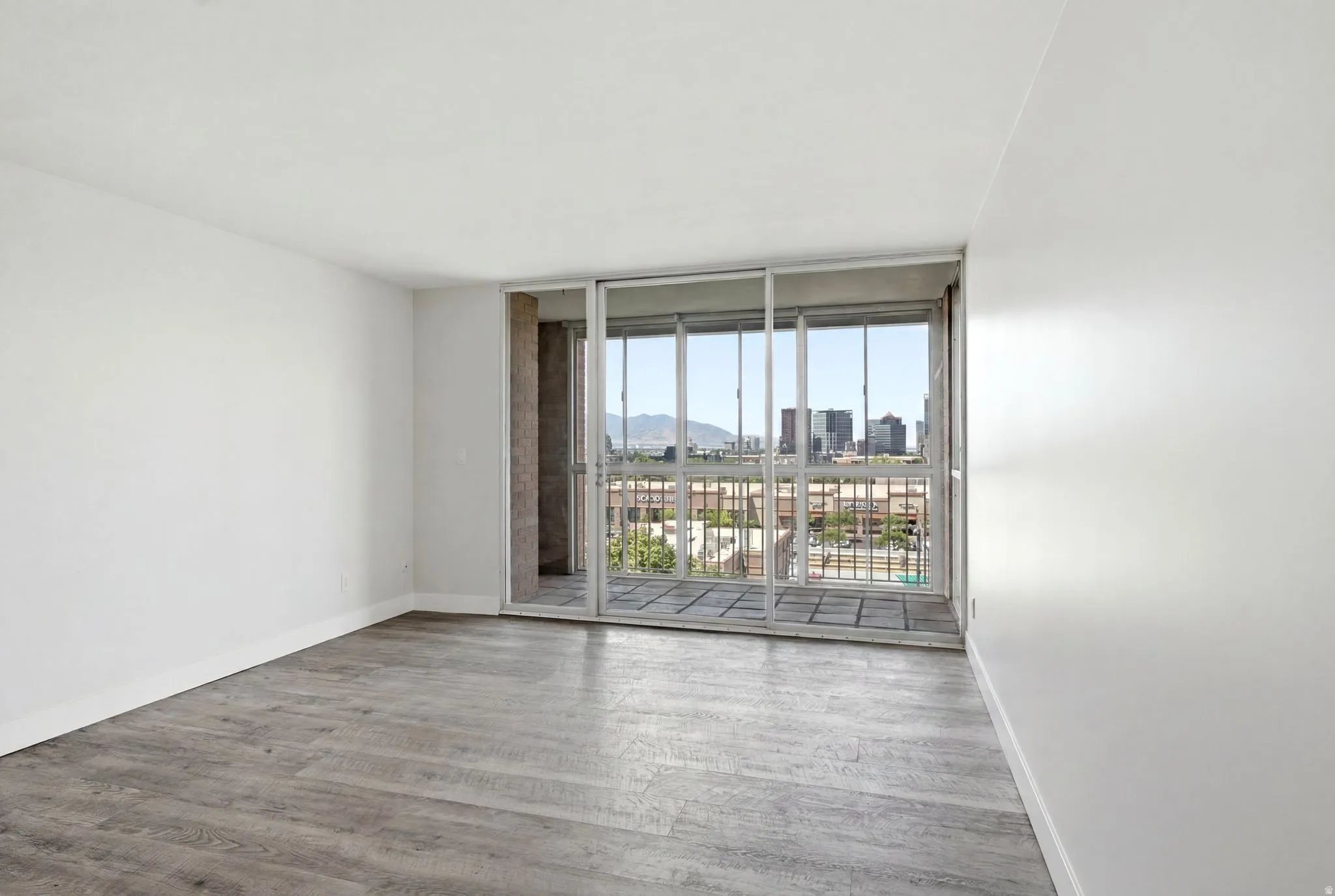 Living space featuring wood-finish flooring and white walls