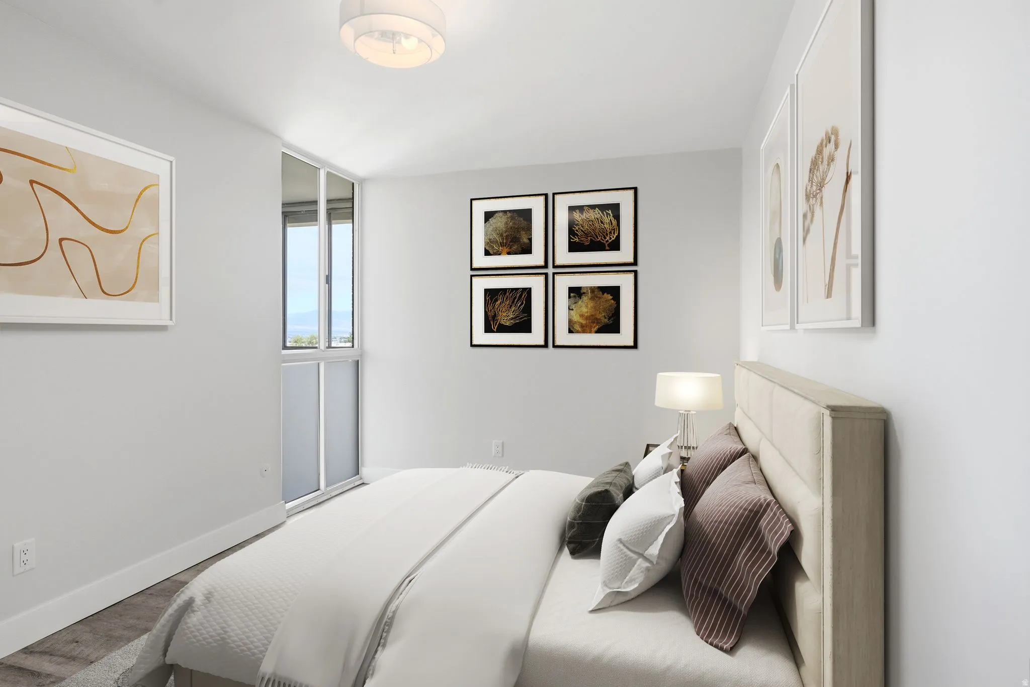 Neutral wall tones, wood-finish flooring, and a contemporary flush mount ceiling light create a bright interior