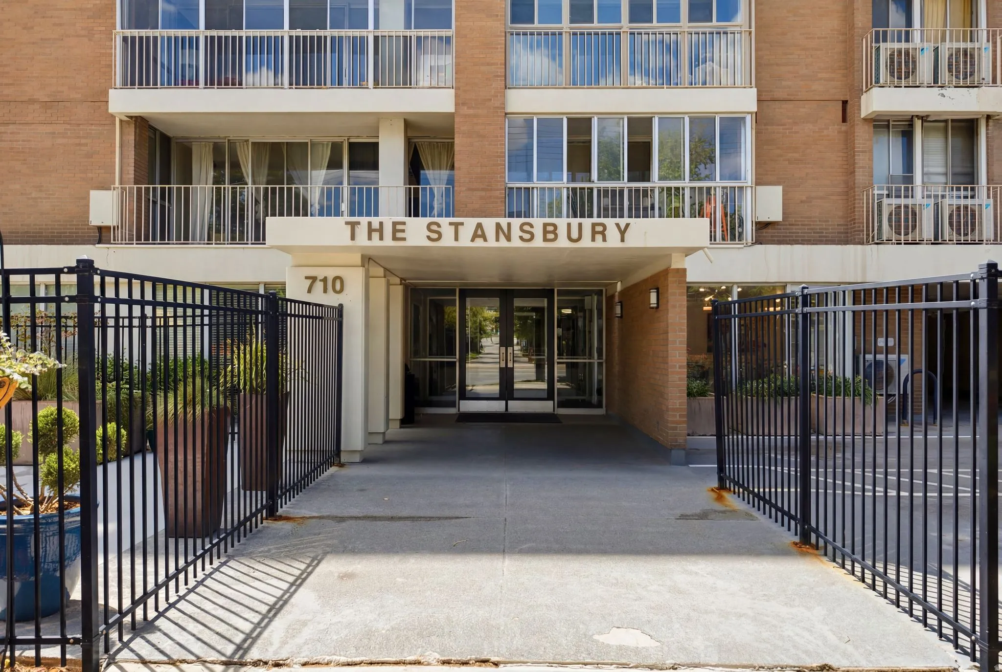 Building entrance featuring "THE STANSBURY" signage and "710" address