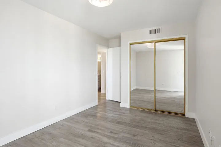 Bright interior space featuring wood-finish flooring, white walls, and a recessed ceiling light