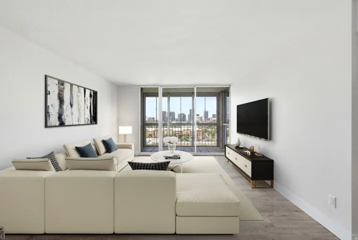 Open living area featuring wood-finish flooring and a glass slider