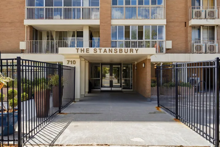 Building entrance featuring "THE STANSBURY" signage and "710" address