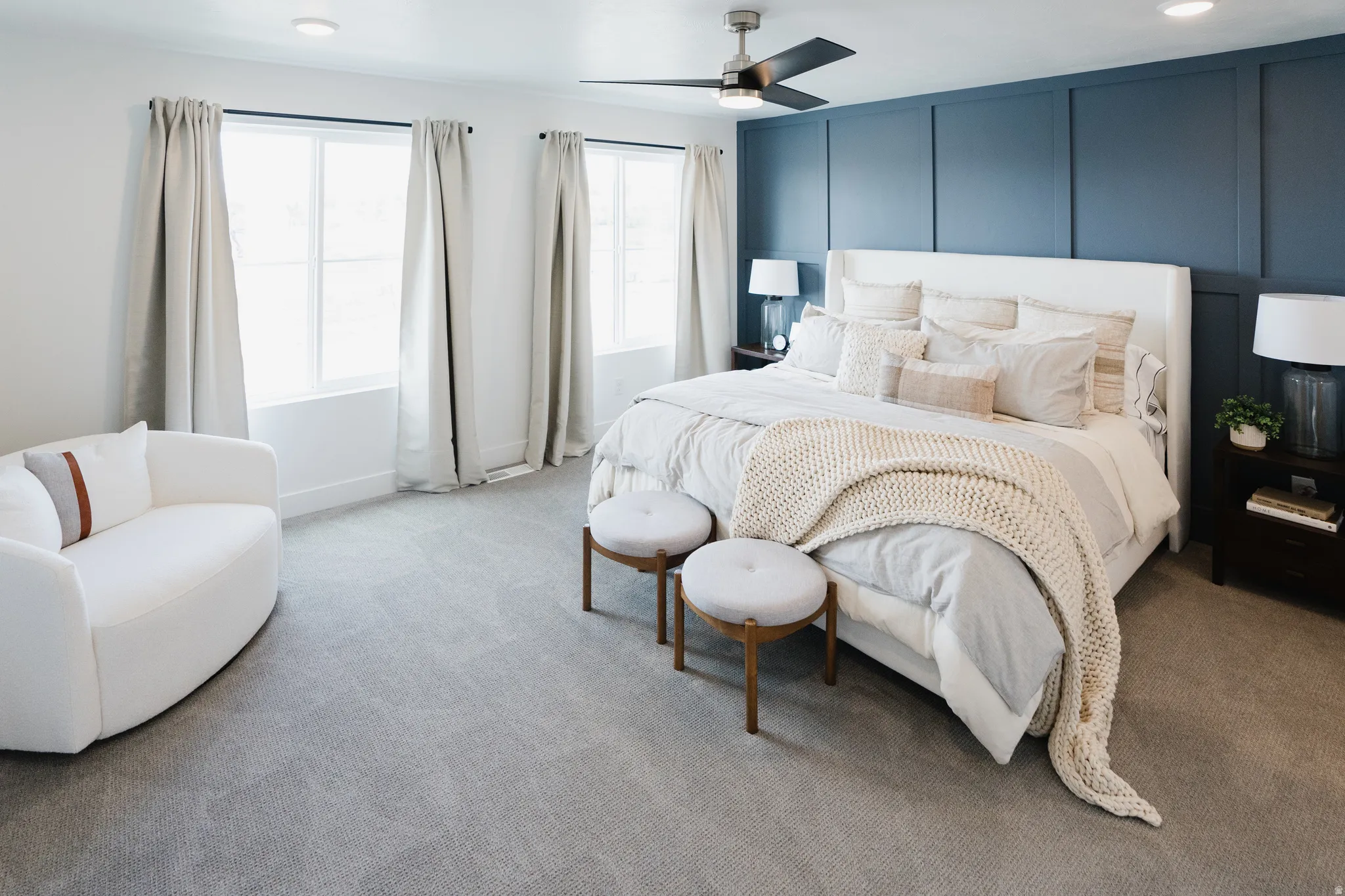 Carpeted interior space featuring a paneled accent wall, recessed lighting, and a ceiling fan