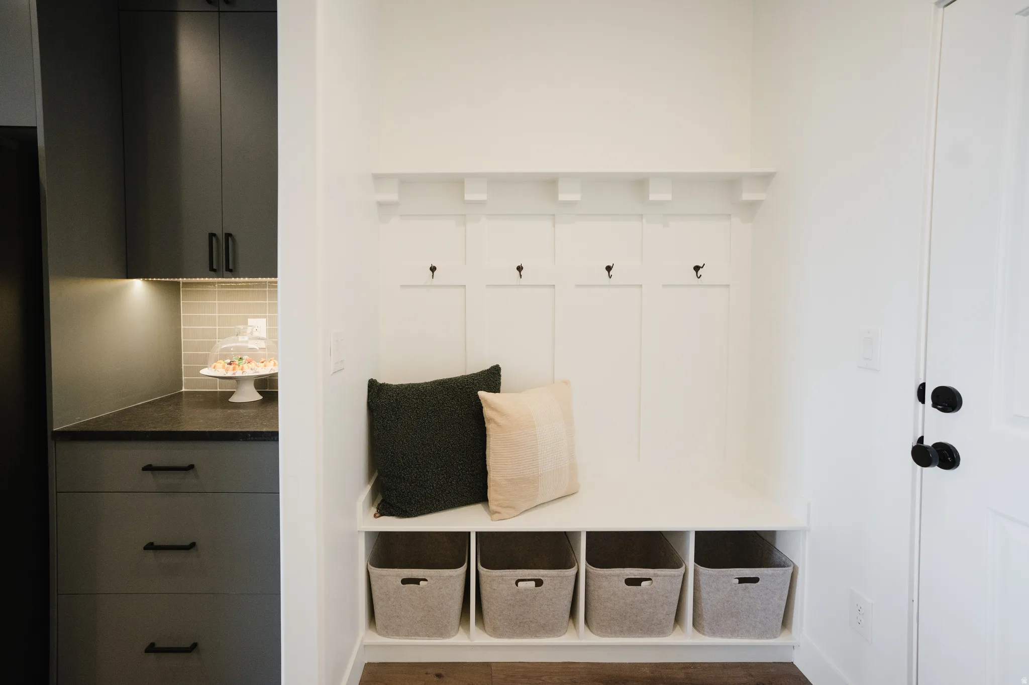 Built-in mudroom bench with cubby storage and coat hooks