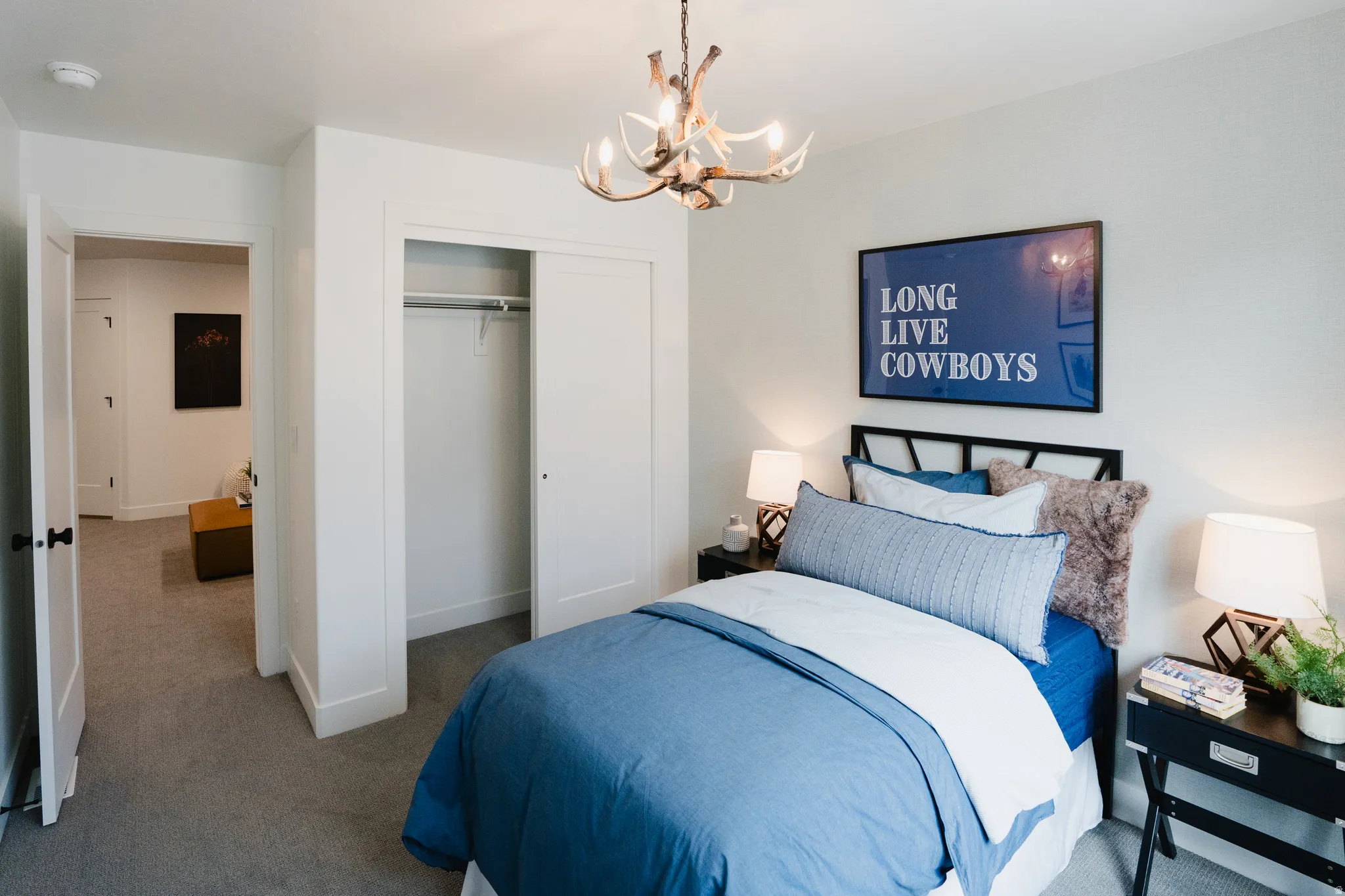 Bedroom with neutral gray carpeting and white walls