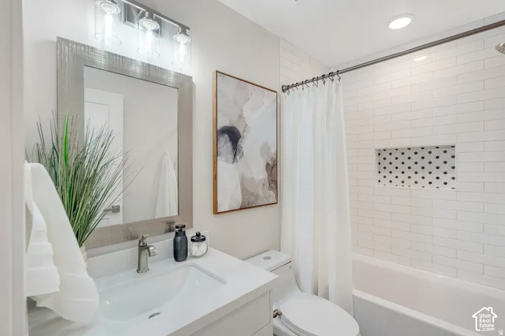 Bathroom featuring a vanity with a rectangular undermount sink and a light-colored countertop