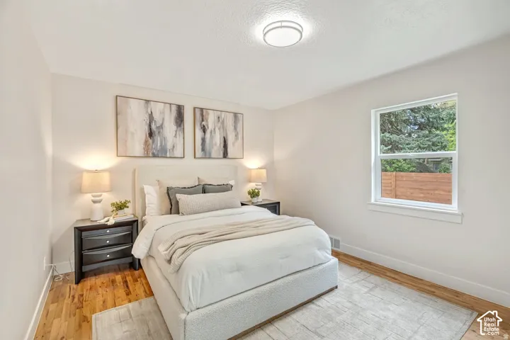 Light-filled room featuring wood-finish flooring, a single window, and a ceiling-mounted flush light fixture