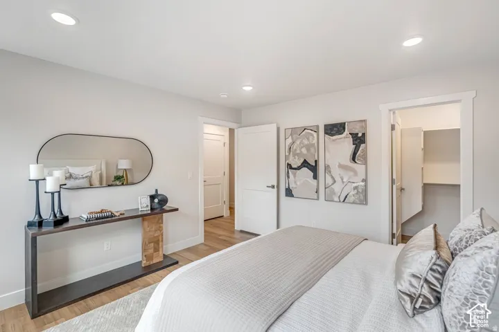 Bedroom featuring recessed lighting, wood-finish flooring, and white baseboards
