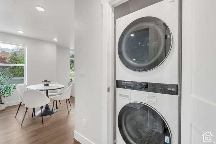 Integrated stacked laundry machines in a dedicated alcove, featuring a white finish