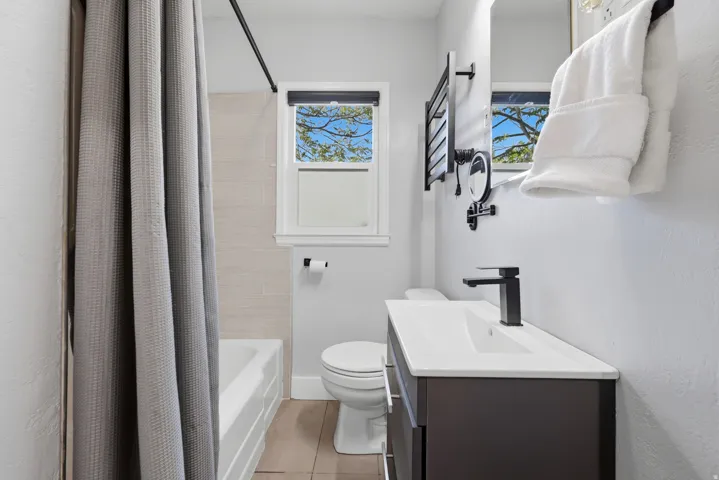 Bathroom featuring a modern single-sink vanity with a dark cabinet base and white countertop