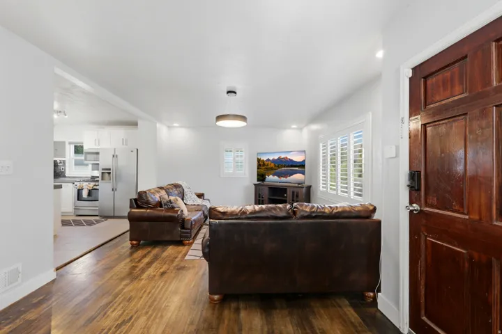 Entryway featuring a dark wood panel door with contemporary hardware