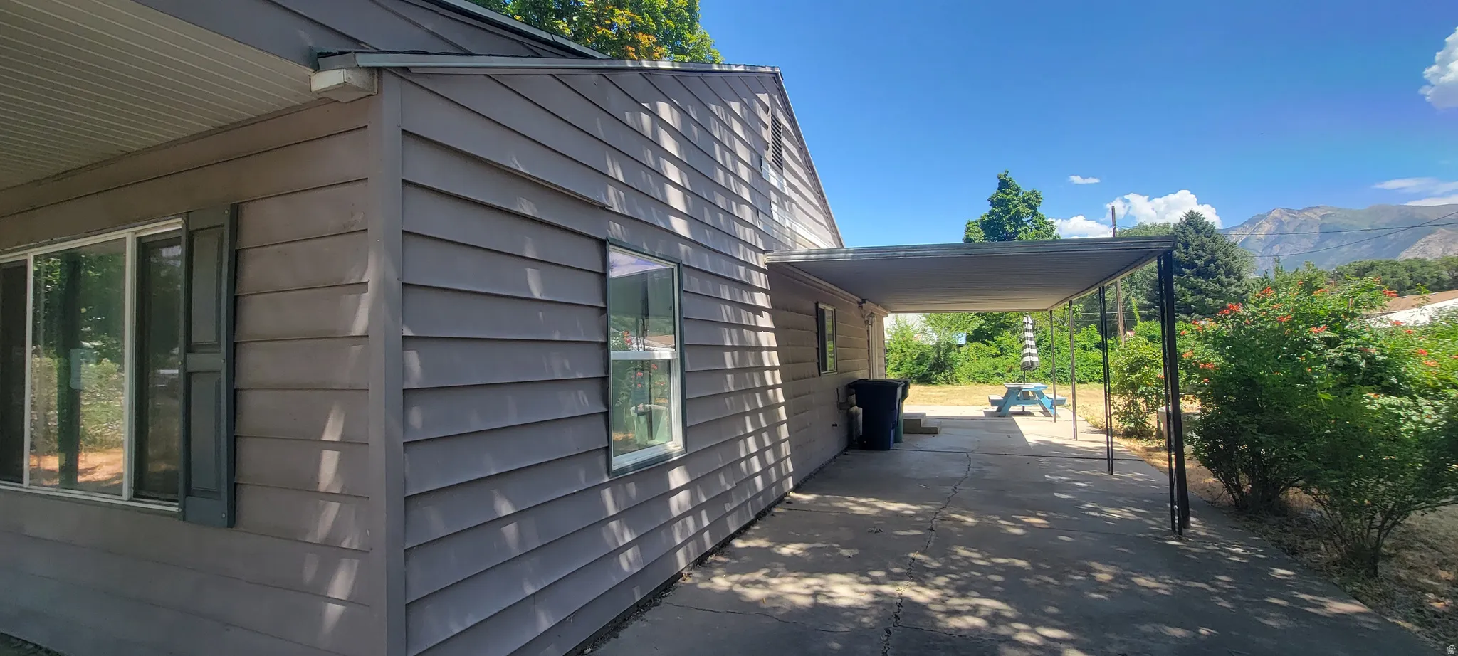 Exterior siding with multiple windows and dark shutters