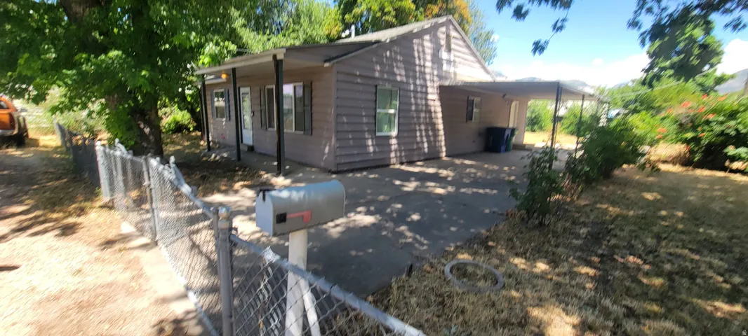 Exterior features include horizontal siding, covered front porch, and an additional covered side patio