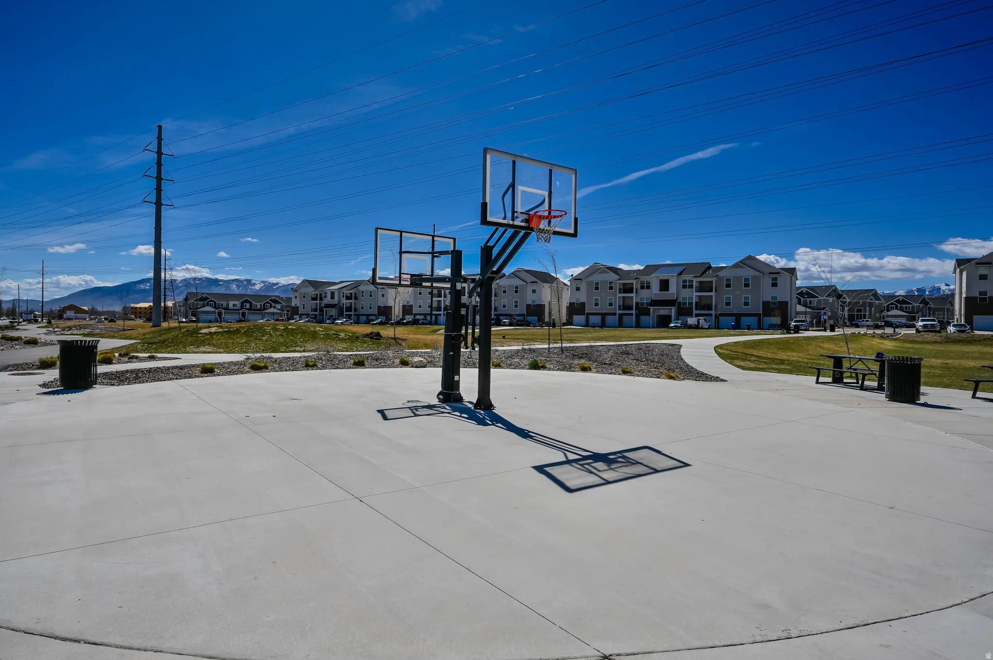 Concrete sports court with dual basketball hoops