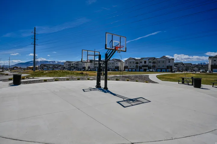 Concrete sports court with dual basketball hoops