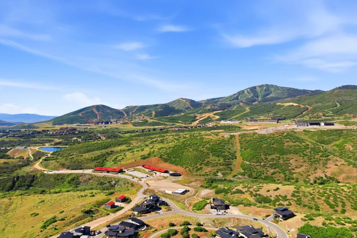 Expansive mountain landscape featuring varied terrain and multiple structures